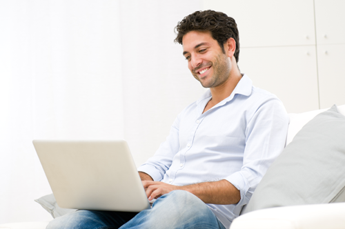 Man smiling as he checks he email