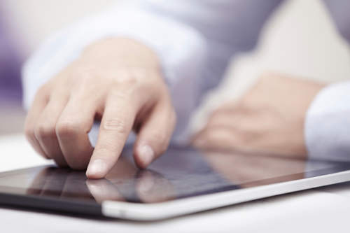 Person clicking an ad on a tablet