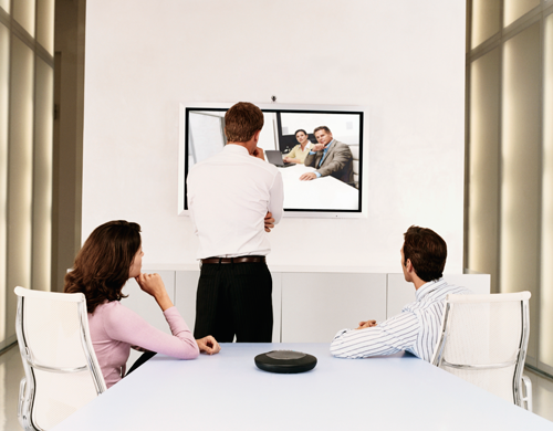 Three people participating in a video meeting over the Internet